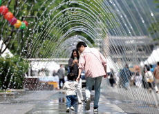 Families Cool off at Seoul’s Gwanghwamun Square Fountain - Photo News